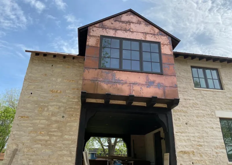Copper metal panel facade on a stone building for Skylight Installation in Buffalo Grove
