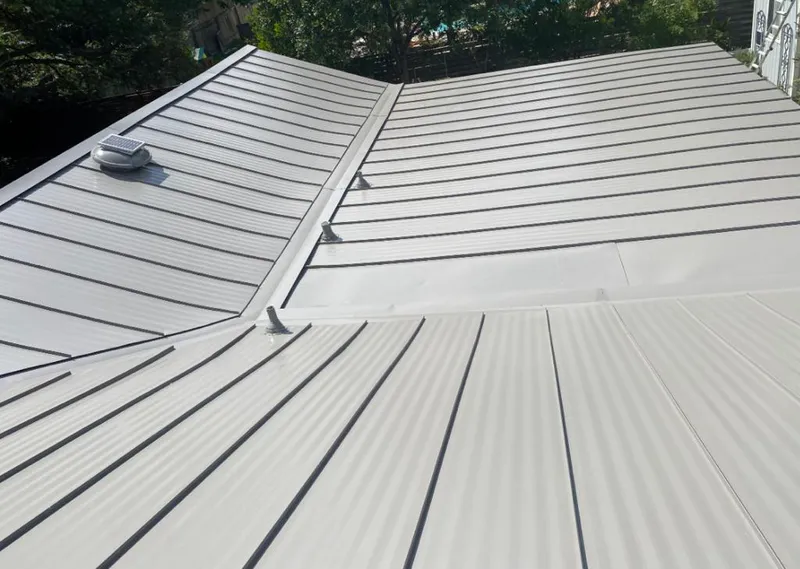 Solar attic fan installed on a metal roof for Roof Ventilation in Buffalo Grove